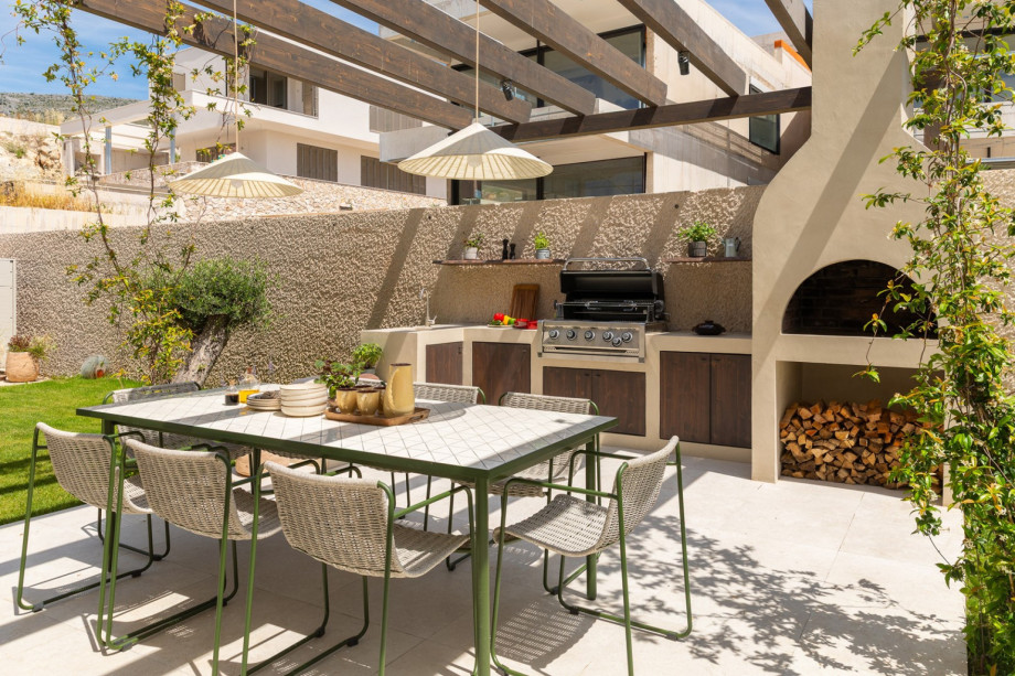 The shaded dining terrace with a gas and wood/charcoal barbecue is perfectly positioned for effortless alfresco meals