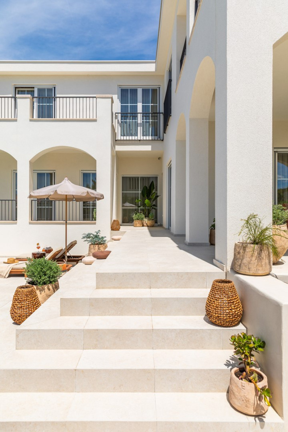 An elegant outdoor terrace welcomes you with stylish furnishings and seamlessly leads to the inviting pool area