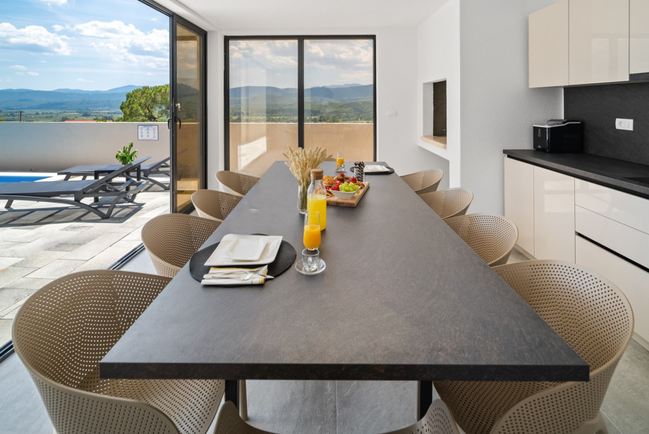 Outdoor area equipped with a traditional wood and charcoal grill, ideal for evening gatherings