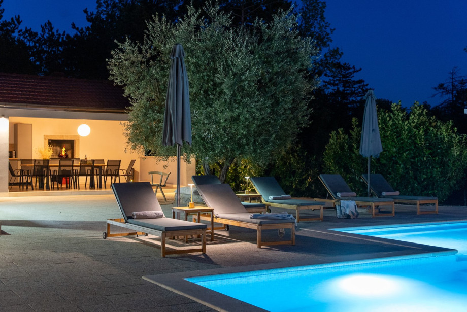 Sun loungers and shade umbrellas set up right by the pool.