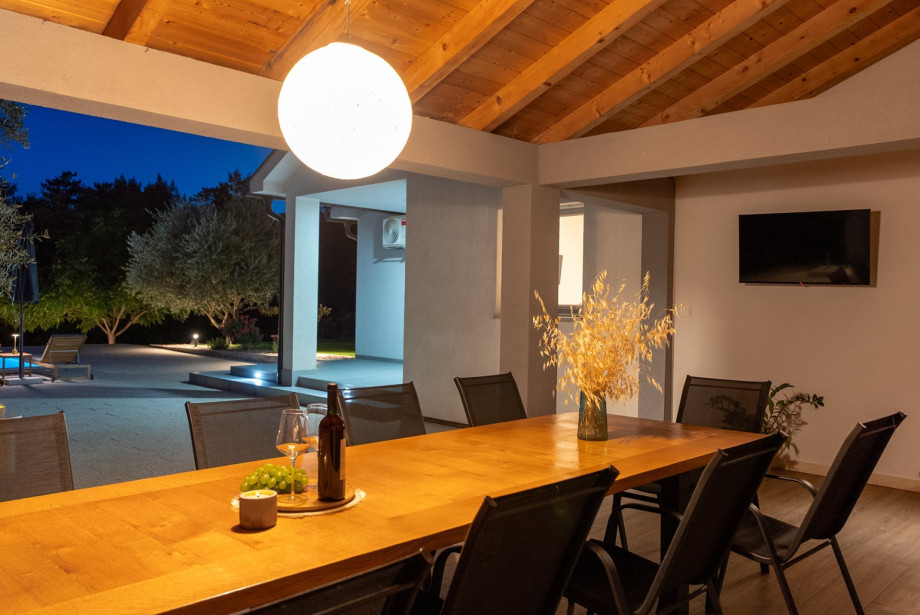 Covered dining table with seating for up to 10 people.