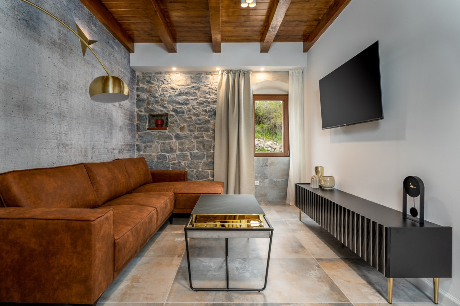Living room with comfy sofa, flat screen TV, and WiFi, where you can spend your best vacation ever.