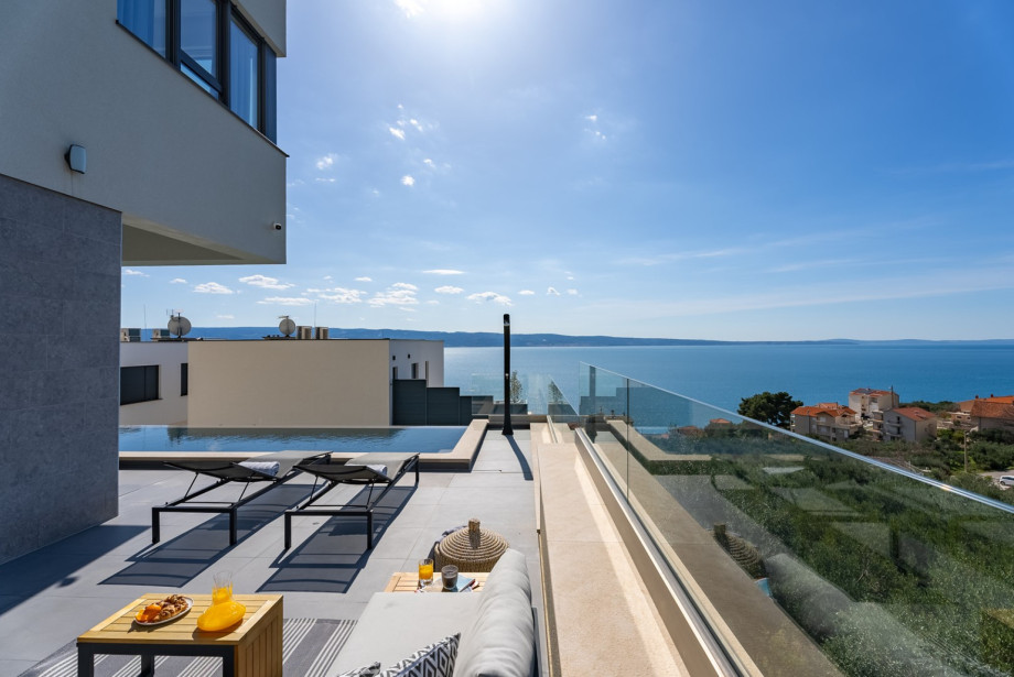Sun-deck area with 5 deck chairs and sea views