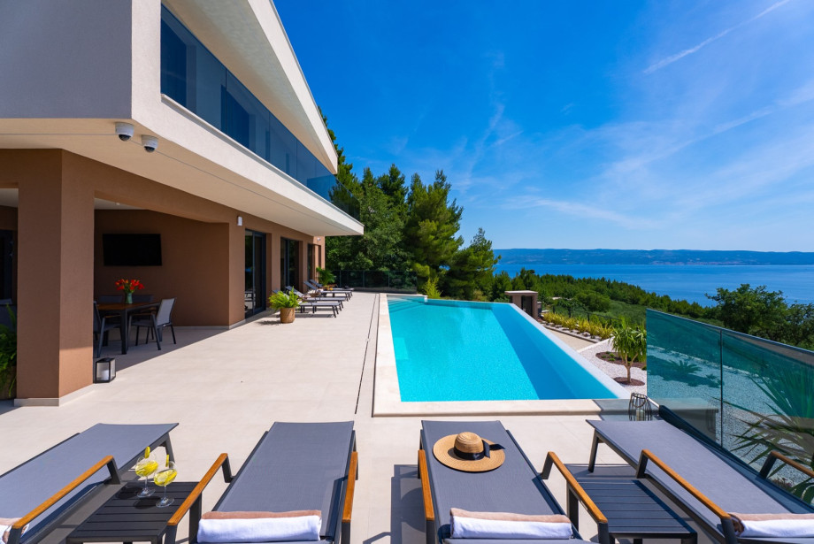 Spacious sun deck equipped with 10 comfortable deck chairs for sunbathing.