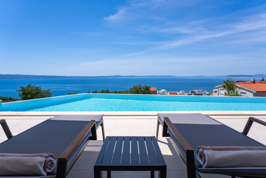Pool area meticulously designed for leisure, enjoyment, and captivating sea views.