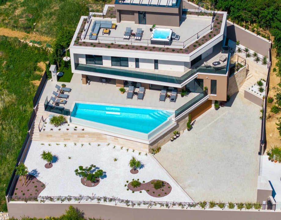 The property is set on a tranquil 908 sqm private plot surrounded by lush greenery.