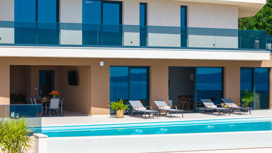 The pool area is meticulously designed for leisure, enjoyment, and sea views.