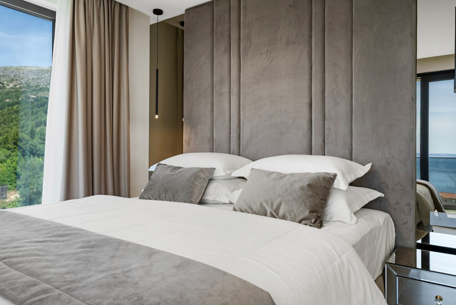 First-floor bedroom with a king-size bed and panoramic sea views.
