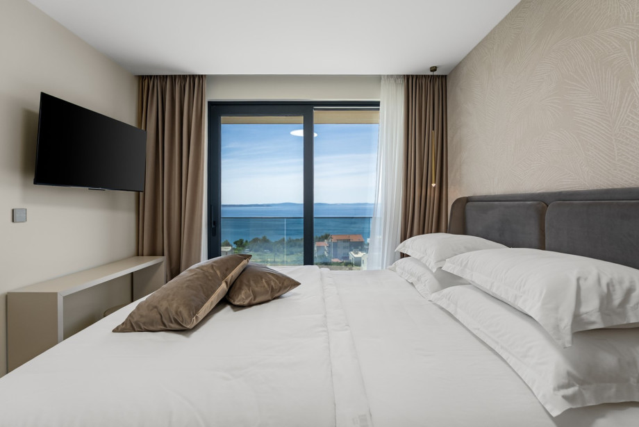Air-conditioned bedroom space with a king-size bed and a flat-screen TV.