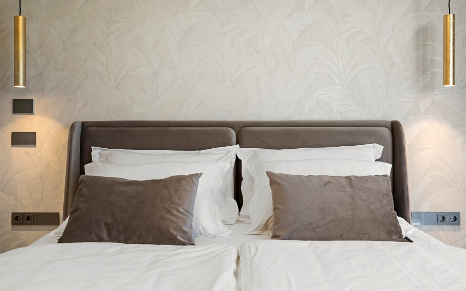 Comfortable king-size bedding setup with modern finishes.