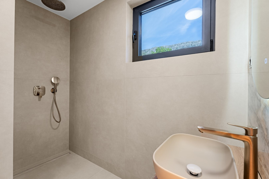 Modern bathroom space equipped with a walk-in shower and premium vanities.