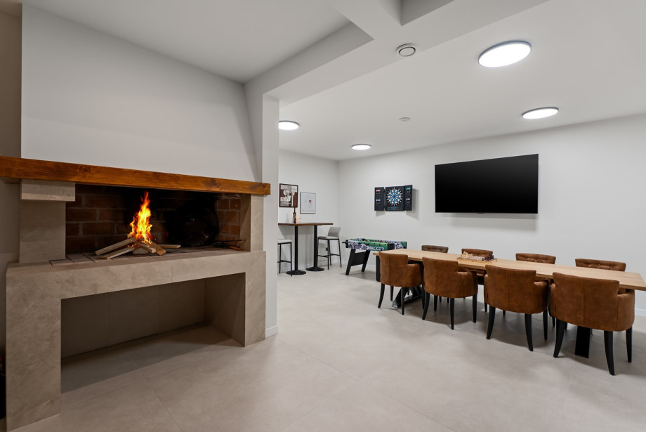 Lower level offers a separate kitchen and a 42 m2 room for group gatherings.