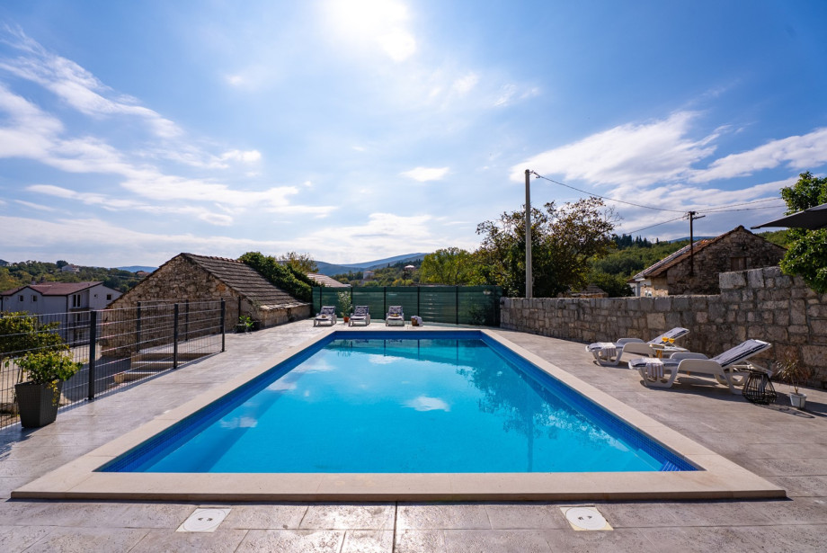 The expansive sun deck surrounds the sparkling 50sqm private swimming pool, providing an ideal spot for relaxation and sunbathing.
