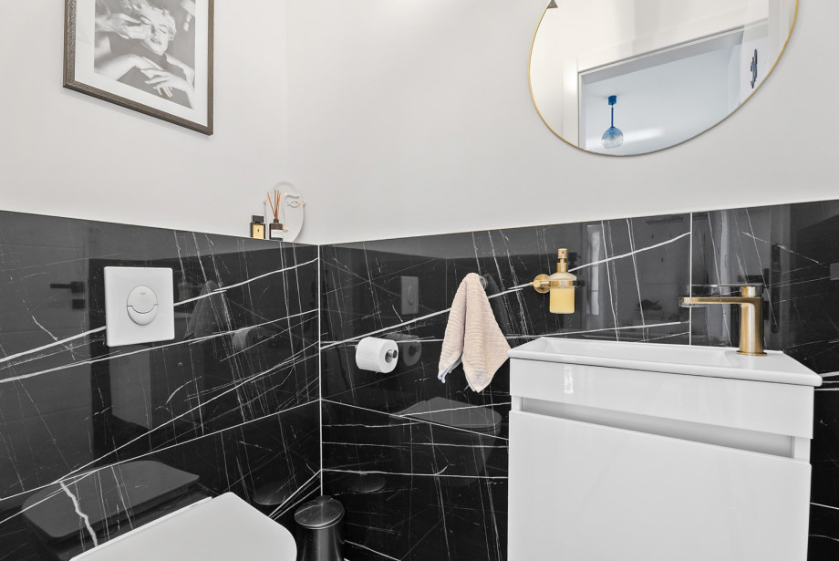 The villa features 4 bathrooms across its levels, including this stylishly designed washroom.