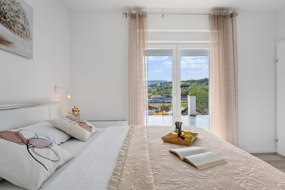 Bedroom 4 is fully air-conditioned and features a balcony overlooking the peaceful neighbourhood.