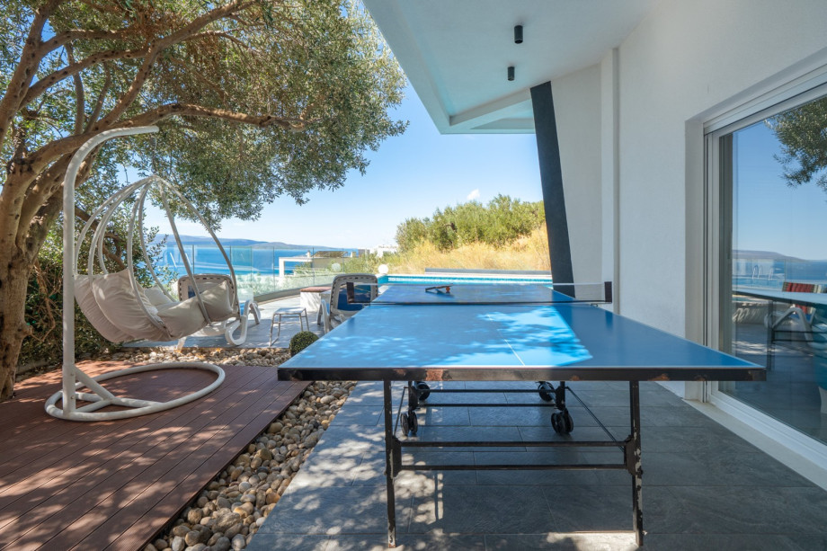 Enjoy a game of table tennis while taking in breathtaking views of the sea and pool.