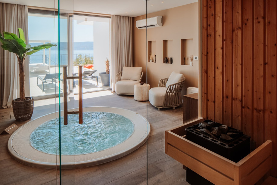 Adjacent to the Jacuzzi, a traditional Finnish-style sauna is finished in warm natural wood, creating a sophisticated atmosphere