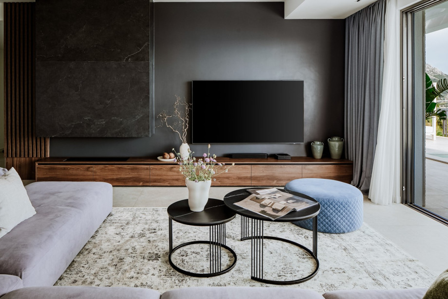 Modern furnished living area with exit to the pool.
