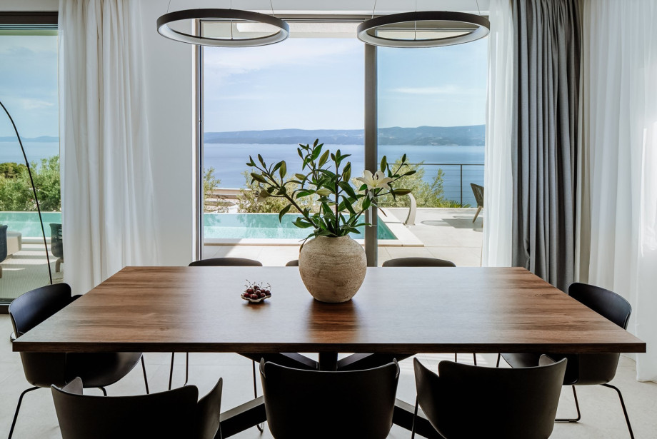 Villa Andoris offer floor-to-ceiling glazing doors toward the pool area.