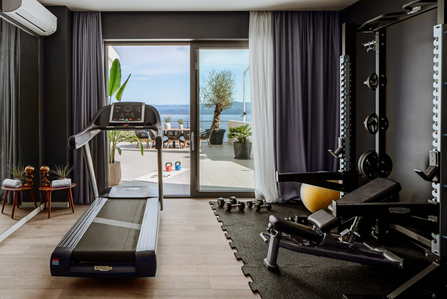 Gym with a Treadmill, Multi-Station Weight Bench, and Weights
