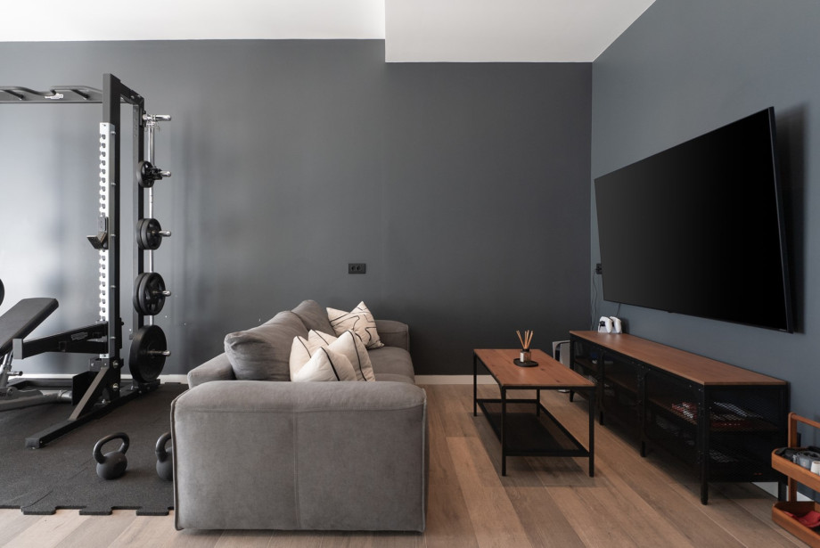 Play zone area with a sofa with a flat-screen TV with a PlayStation 5 for younger generations.