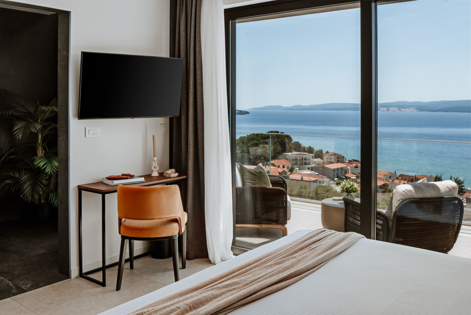 Bedroom No3 with a balcony with outdoor furniture and sea views.