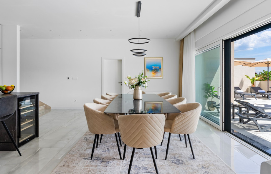 Meticulously decorated spacious dining room with a table for ten people