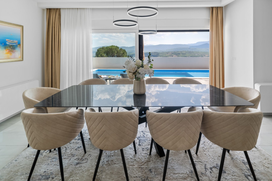 A comfortable dining table perfect for enjoying homemade meals together overlooking the pool and sundeck