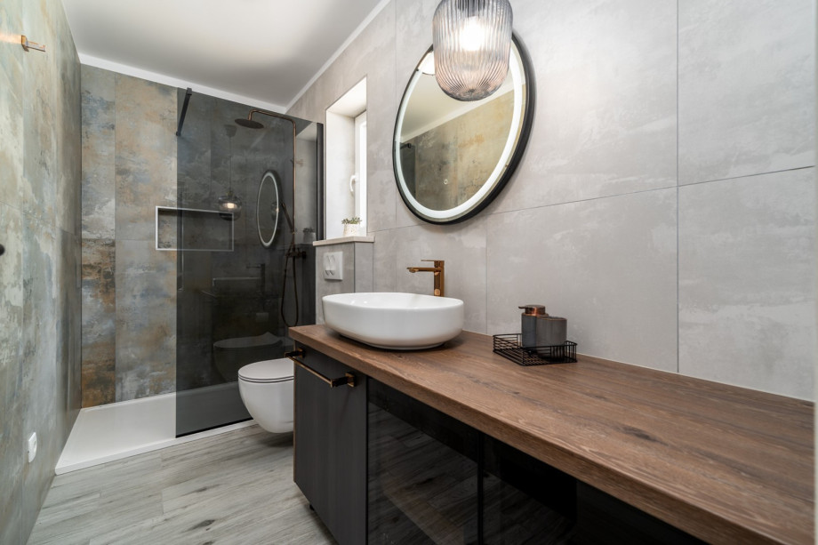 An en-suite bathroom with a shower, a sink, and a toilet