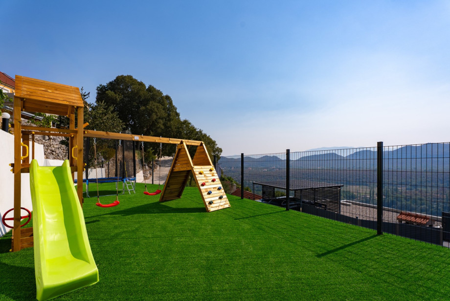 There is a playground for youngest and there is a covered parking lot for 3 cars with video surveillance